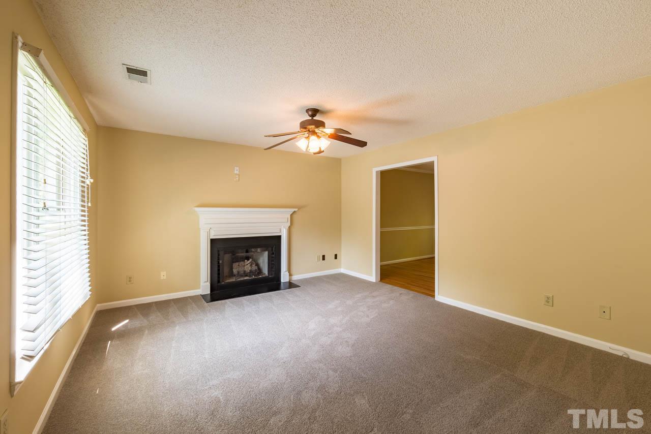 3608 Singleleaf Lane Raleigh, NC 27616 - Photo 2 of 23 a view of an empty room with a fireplace and a window