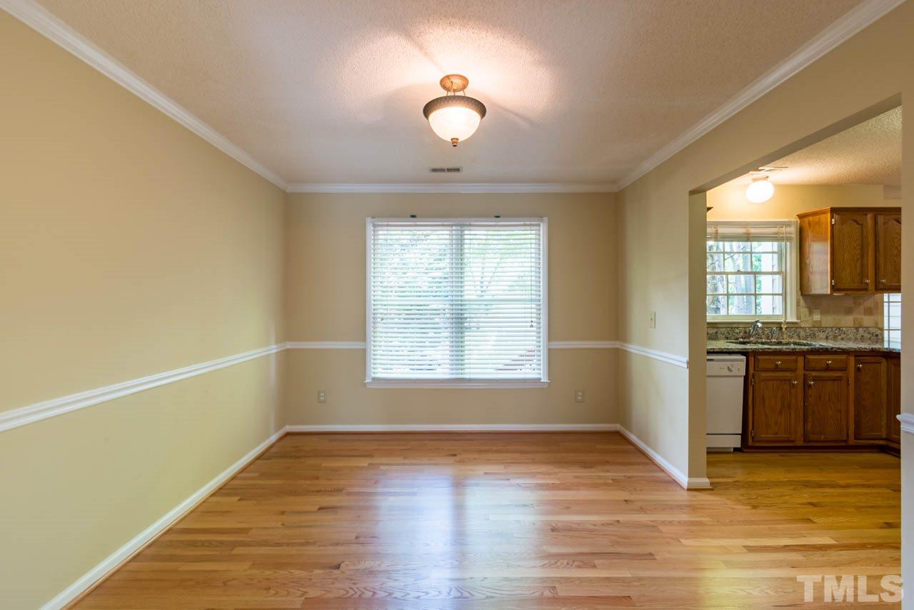 3608 Singleleaf Lane Raleigh, NC 27616 - Photo 3 of 23 a view of an empty room with a window and wooden floor