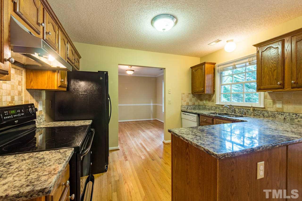 3608 Singleleaf Lane Raleigh, NC 27616 - Photo 4 of 23 a kitchen with stainless steel appliances granite countertop a sink stove and refrigerator