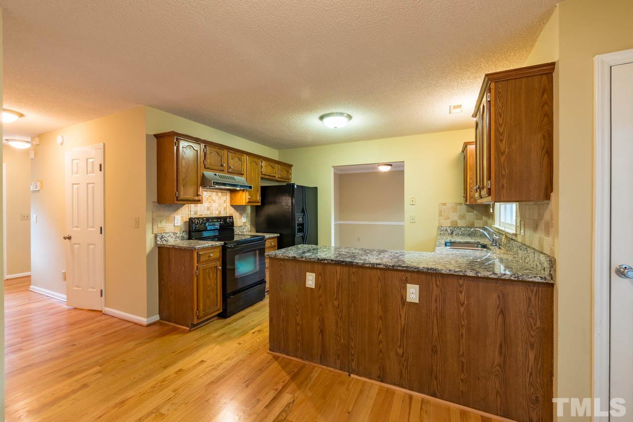 3608 Singleleaf Lane Raleigh, NC 27616 - Photo 6 of 23 a kitchen with granite countertop a sink and counter space