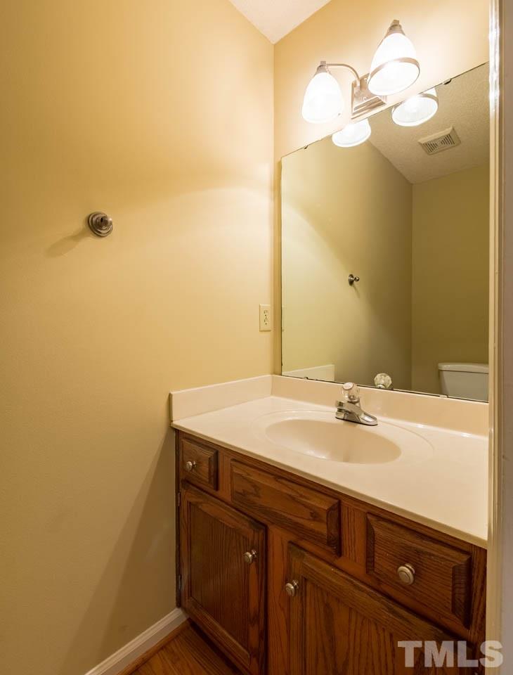 3608 Singleleaf Lane Raleigh, NC 27616 - Photo 7 of 23 a bathroom with a sink and a mirror
