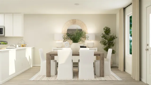 a dining room with furniture and a potted plant