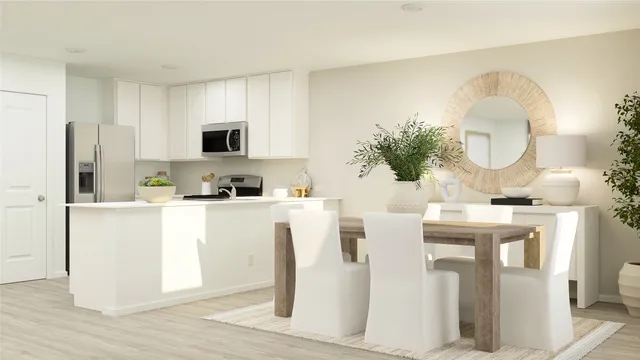 a kitchen with stainless steel appliances granite countertop a white cabinets a stove a sink and a refrigerator