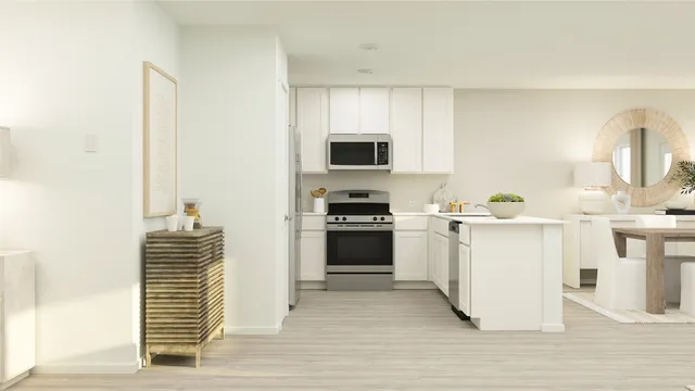 a kitchen with a sink and a stove top oven with wooden floor