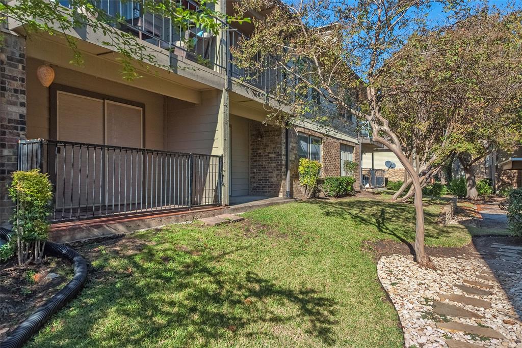 5300 Keller Springs Road, Unit 1048 Dallas, TX 75248 - Photo 30 of 38 View of the balcony featuring trees nearby and neatly trimmed bushes.