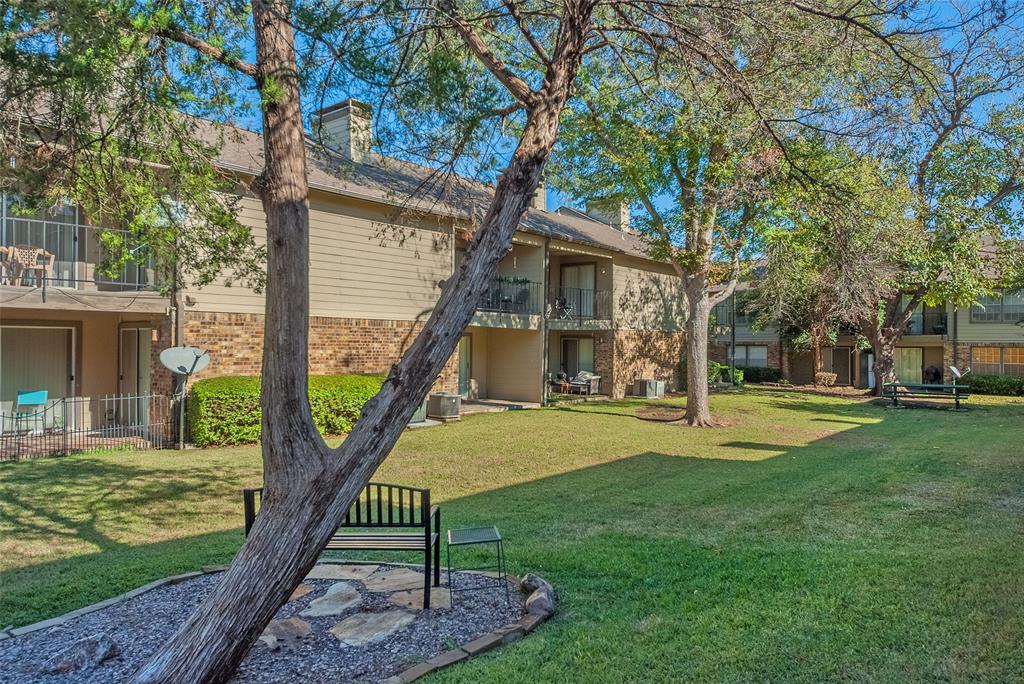 5300 Keller Springs Road, Unit 1048 Dallas, TX 75248 - Photo 31 of 38 A charming apartment complex yard showcasing lush greenery, inviting for socializing.