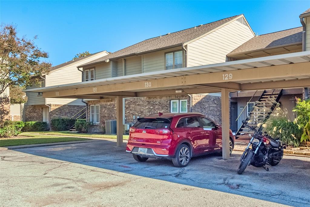 5300 Keller Springs Road, Unit 1048 Dallas, TX 75248 - Photo 34 of 38 The two-story apartment building, surrounded by greenery.