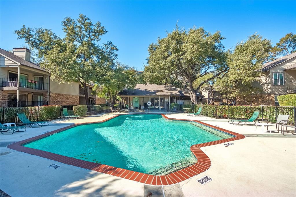 5300 Keller Springs Road, Unit 1048 Dallas, TX 75248 - Photo 6 of 38 A sparkling pool featuring sun loungers and lush landscaping, perfect for relaxation and leisure activities.