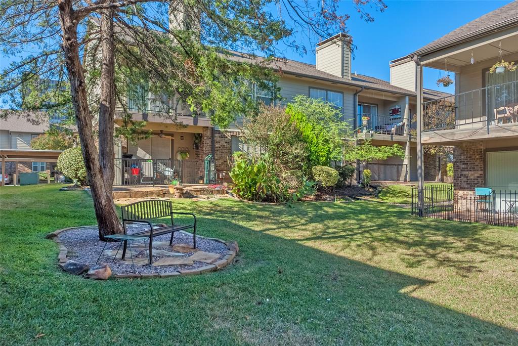 5300 Keller Springs Road, Unit 1048 Dallas, TX 75248 - Photo 7 of 38 A charming apartment complex yard showcasing lush greenery, inviting for socializing.