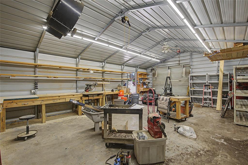 1701 Central Road Weatherford, TX 76088 - Photo 35 of 40 Workshop with ceiling fan, lighting, and metal walls.