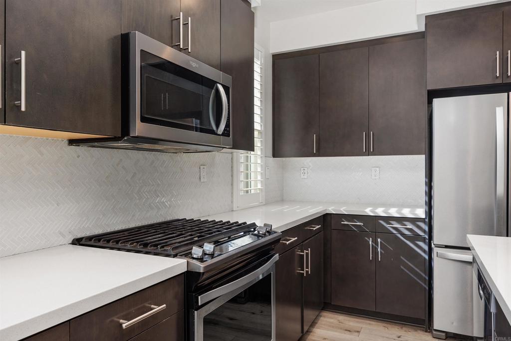 1309 Via Lucero Oceanside, CA 92056 - Photo 14 of 50 a kitchen with a stove and a microwave