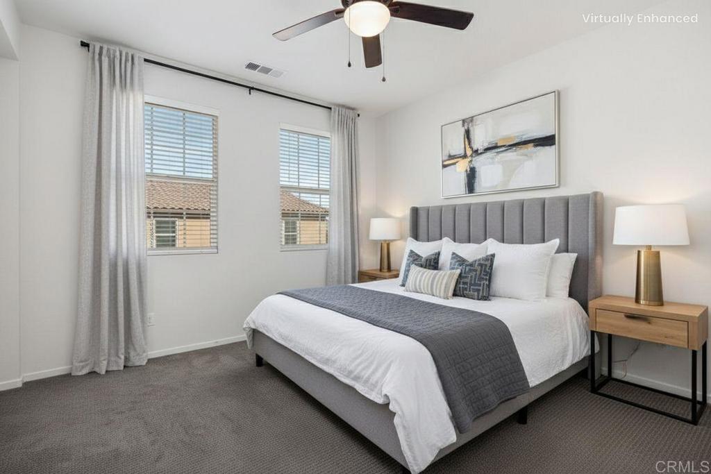 1309 Via Lucero Oceanside, CA 92056 - Photo 23 of 50 a large bed sitting in a bedroom next to a window and a chandelier