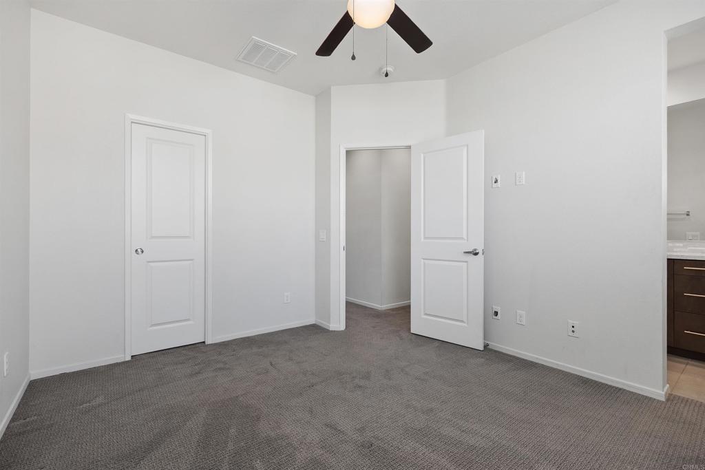 1309 Via Lucero Oceanside, CA 92056 - Photo 24 of 50 an empty room with ceiling fan