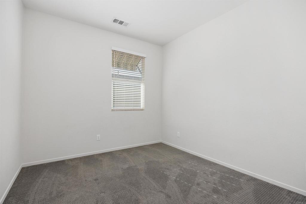 1309 Via Lucero Oceanside, CA 92056 - Photo 30 of 50 an empty room with a window