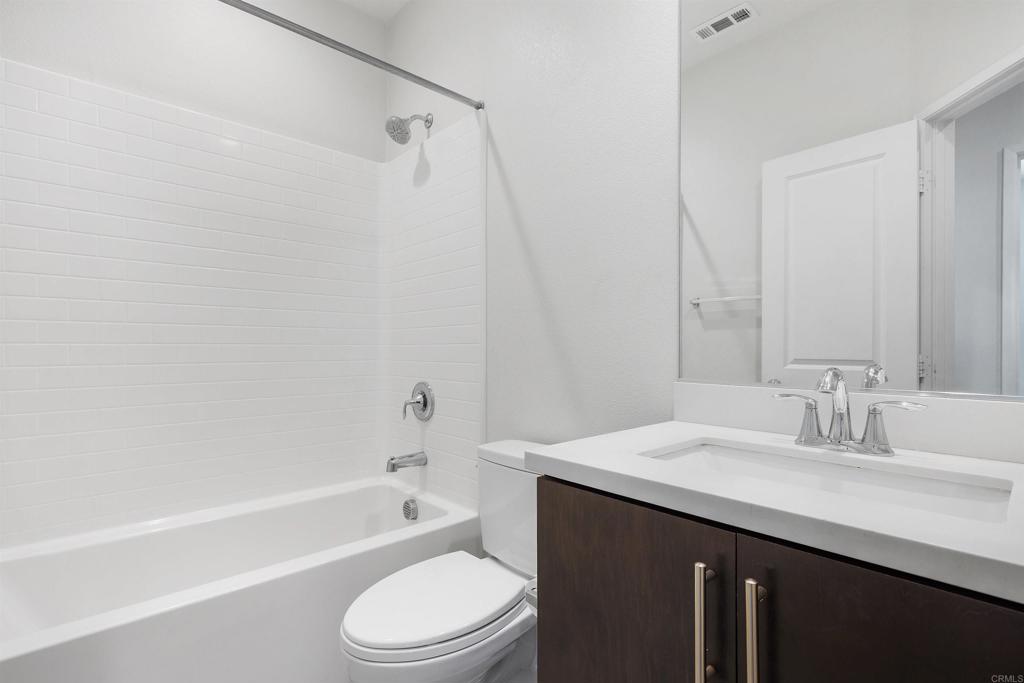 1309 Via Lucero Oceanside, CA 92056 - Photo 35 of 50 a bathroom with a sink a toilet and a bathtub