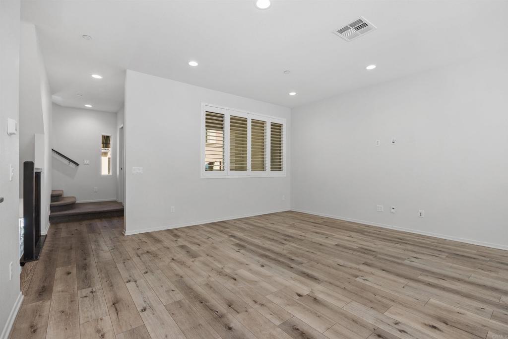 1309 Via Lucero Oceanside, CA 92056 - Photo 7 of 50 an empty room with wooden floor and windows