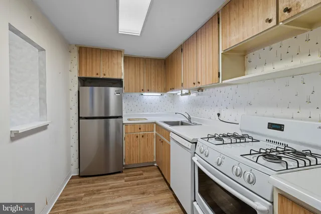 a kitchen with a stove a sink and a refrigerator
