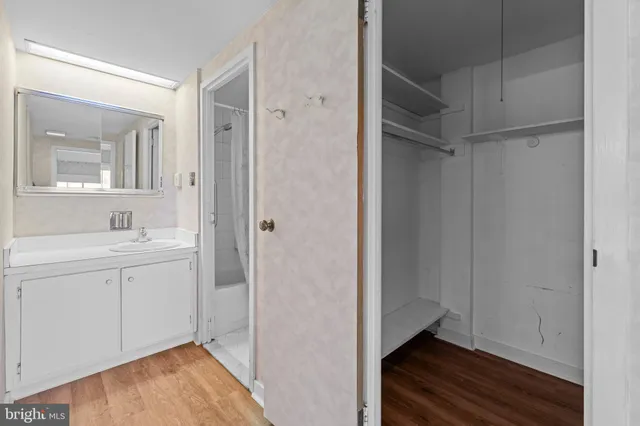 a view of an empty room with wooden floor