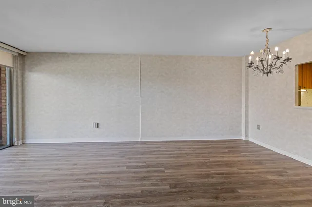 a view of wooden floor and windows in a room