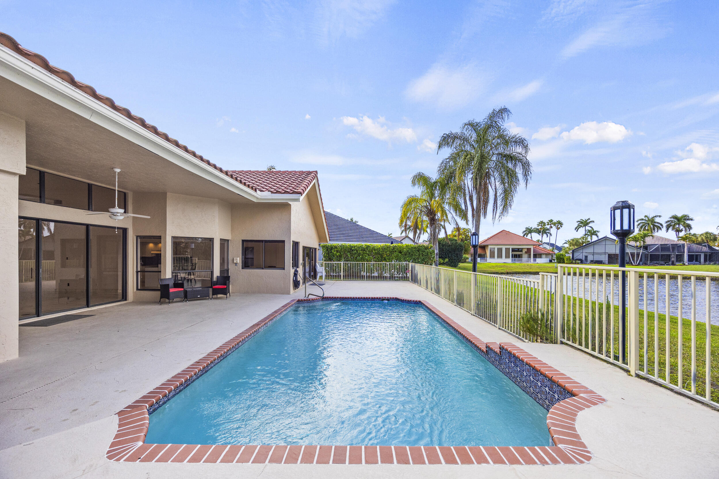 10747 Stonebridge Boulevard Boca Raton, FL 33498 - Photo 46 of 75 a view of a house with swimming pool and sitting area