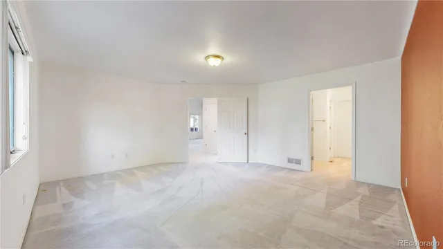 an empty room with closet area