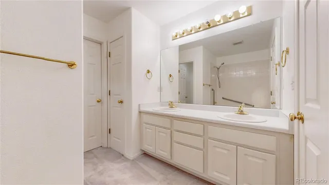 a bathroom with a double vanity sink mirror and