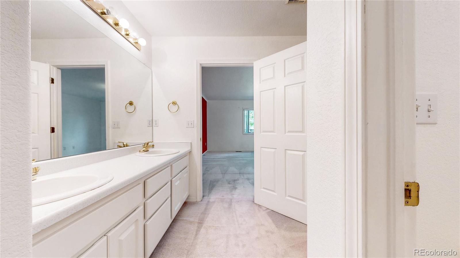4367 Quail Street Wheat Ridge, CO 80033 - Photo 22 of 50 a bathroom with a sink and a mirror