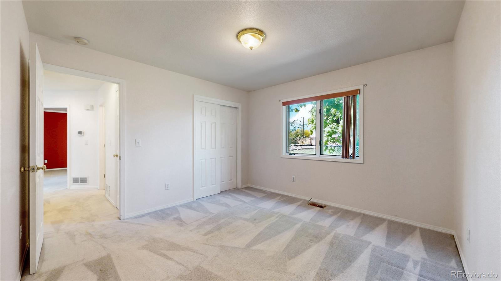 4367 Quail Street Wheat Ridge, CO 80033 - Photo 24 of 50 an empty room with windows