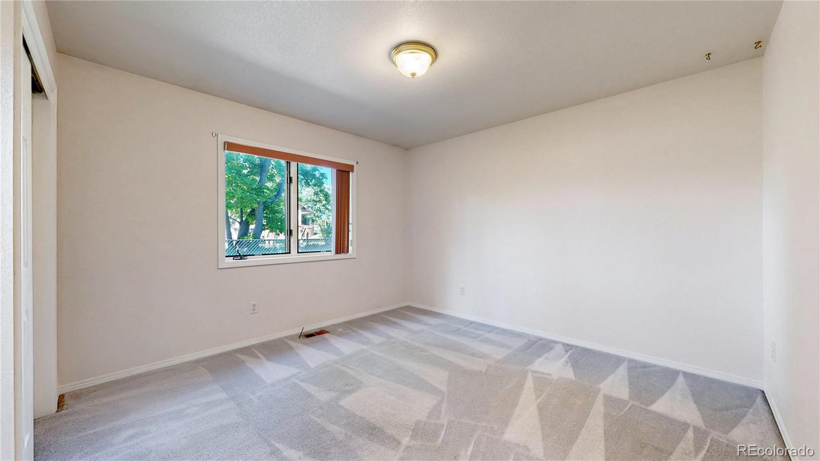 4367 Quail Street Wheat Ridge, CO 80033 - Photo 25 of 50 an empty room with a window