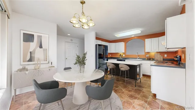 a kitchen with a table chairs and a dining table