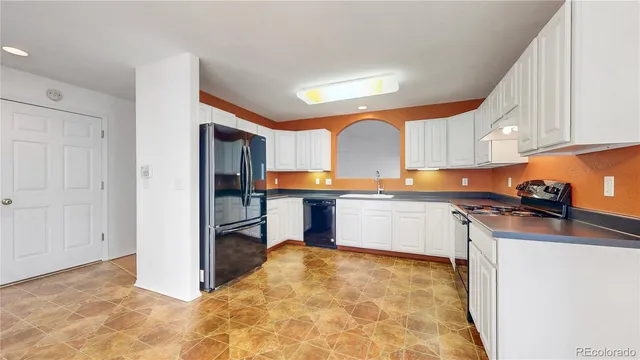 a kitchen with stainless steel appliances granite countertop a sink and cabinets
