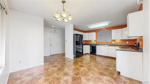 a view of a kitchen with a sink and cabinets