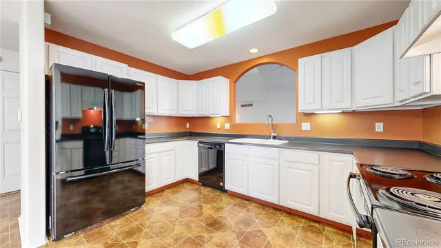a kitchen with stainless steel appliances granite countertop a sink and cabinets