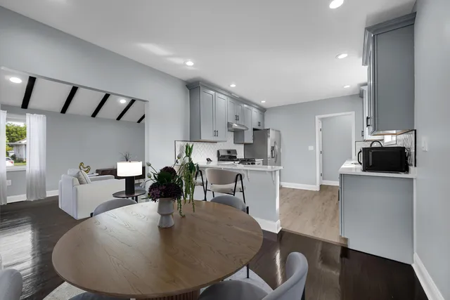 a living room with lots of furniture and kitchen view