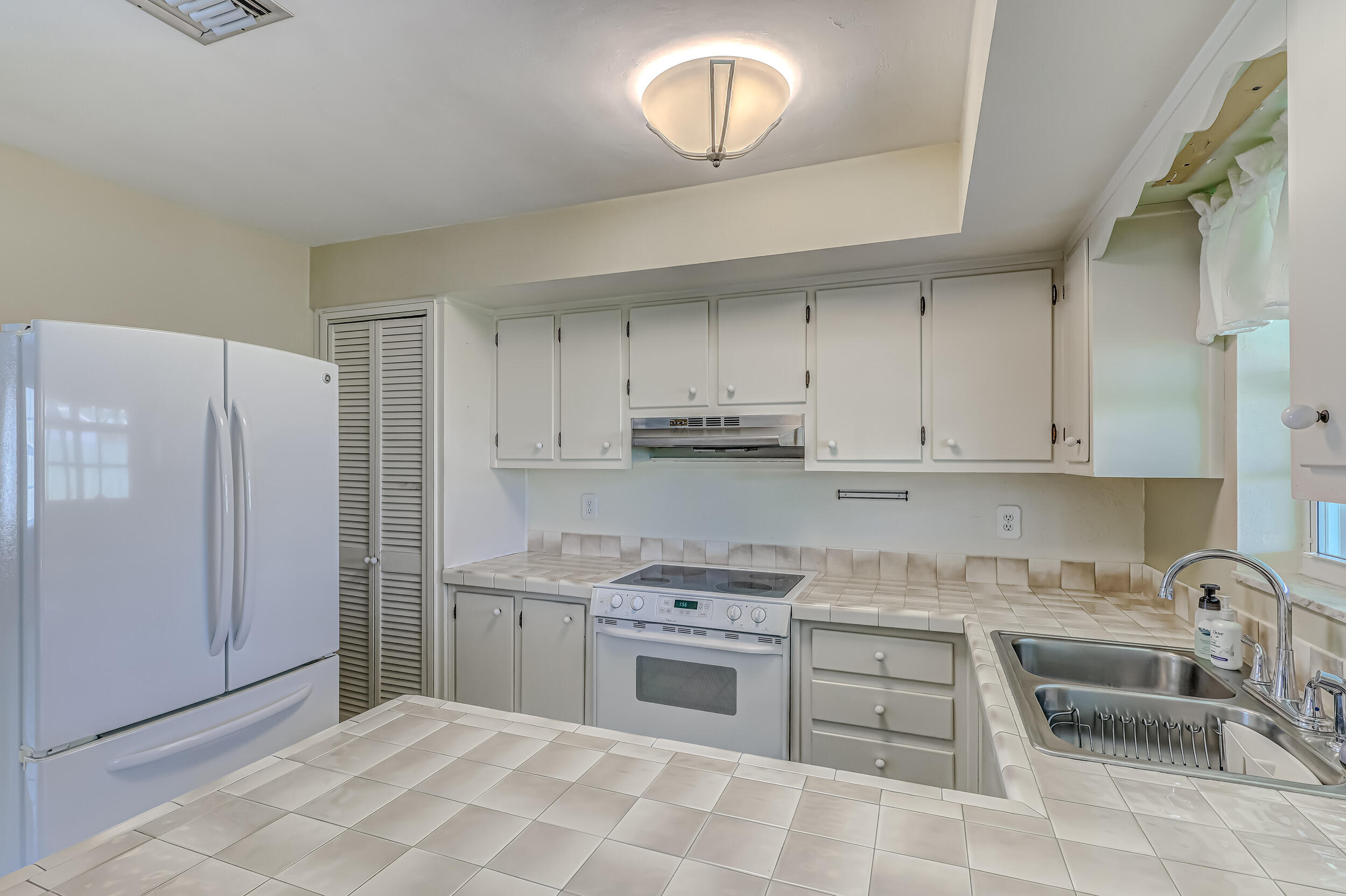 1618 Maypop Road West Palm Beach, FL 33415 - Photo 28 of 81 a kitchen with stainless steel appliances granite countertop a stove a sink and a refrigerator