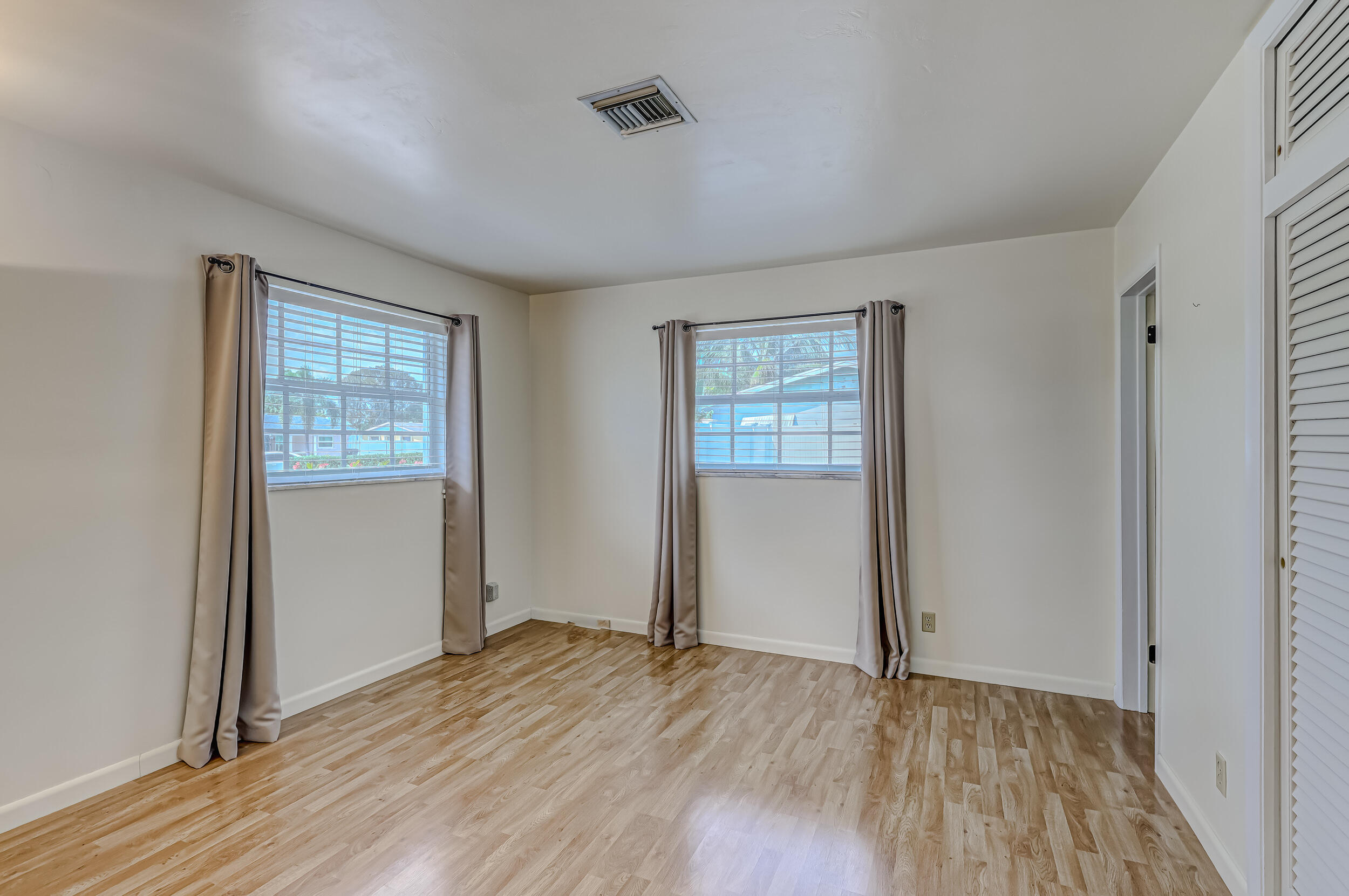 1618 Maypop Road West Palm Beach, FL 33415 - Photo 39 of 81 an empty room with wooden floor and windows