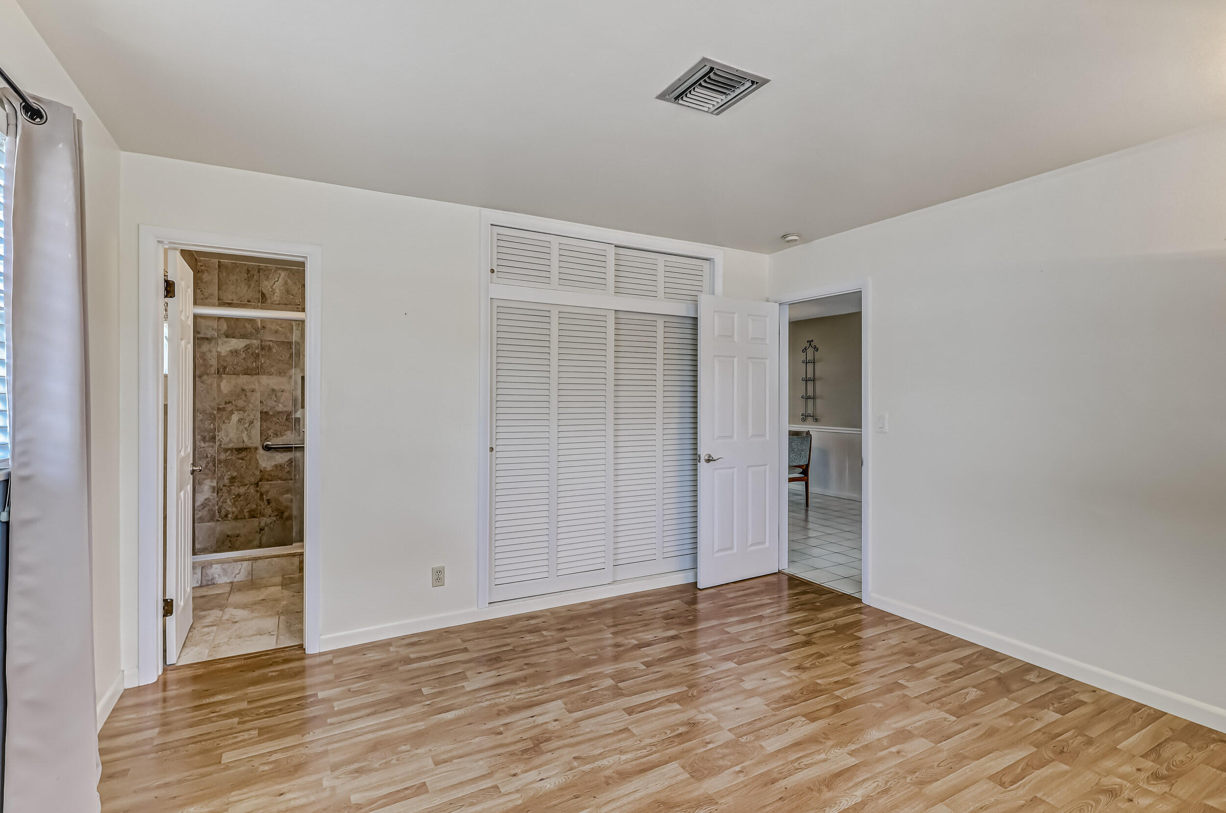 1618 Maypop Road West Palm Beach, FL 33415 - Photo 40 of 81 a view of an empty room with wooden floor and a window