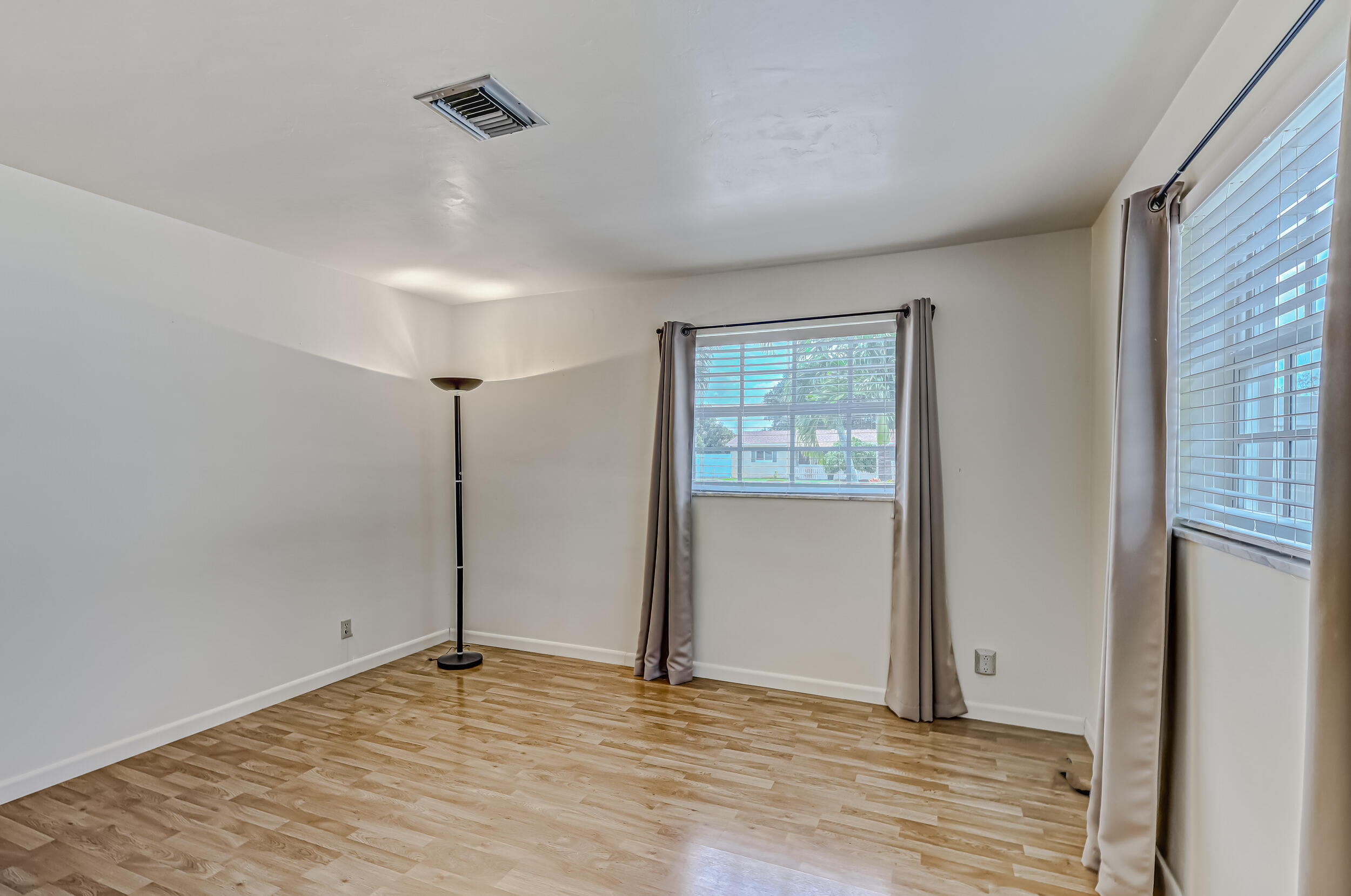 1618 Maypop Road West Palm Beach, FL 33415 - Photo 41 of 81 a view of an empty room with wooden floor and a window