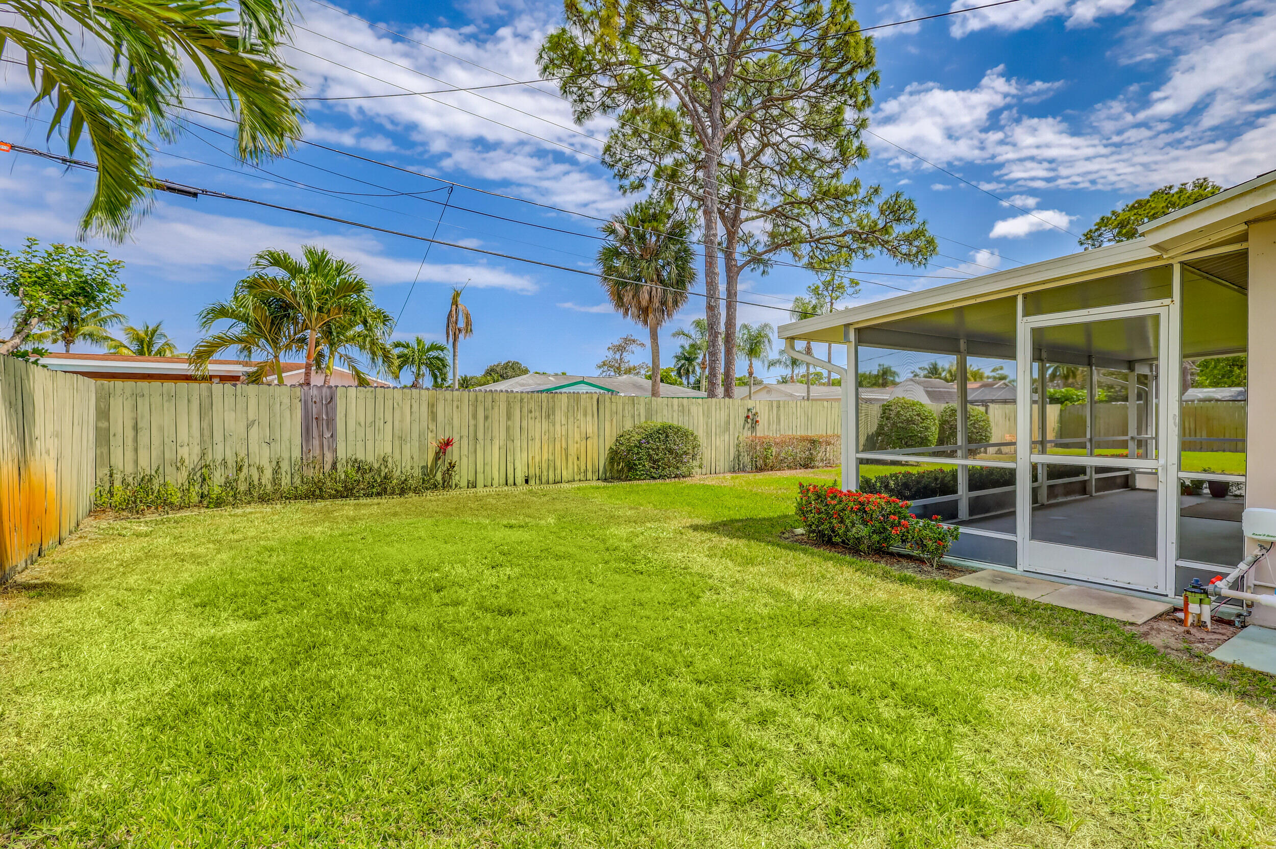 1618 Maypop Road West Palm Beach, FL 33415 - Photo 53 of 81 a view of a backyard with table and chairs and potted plants
