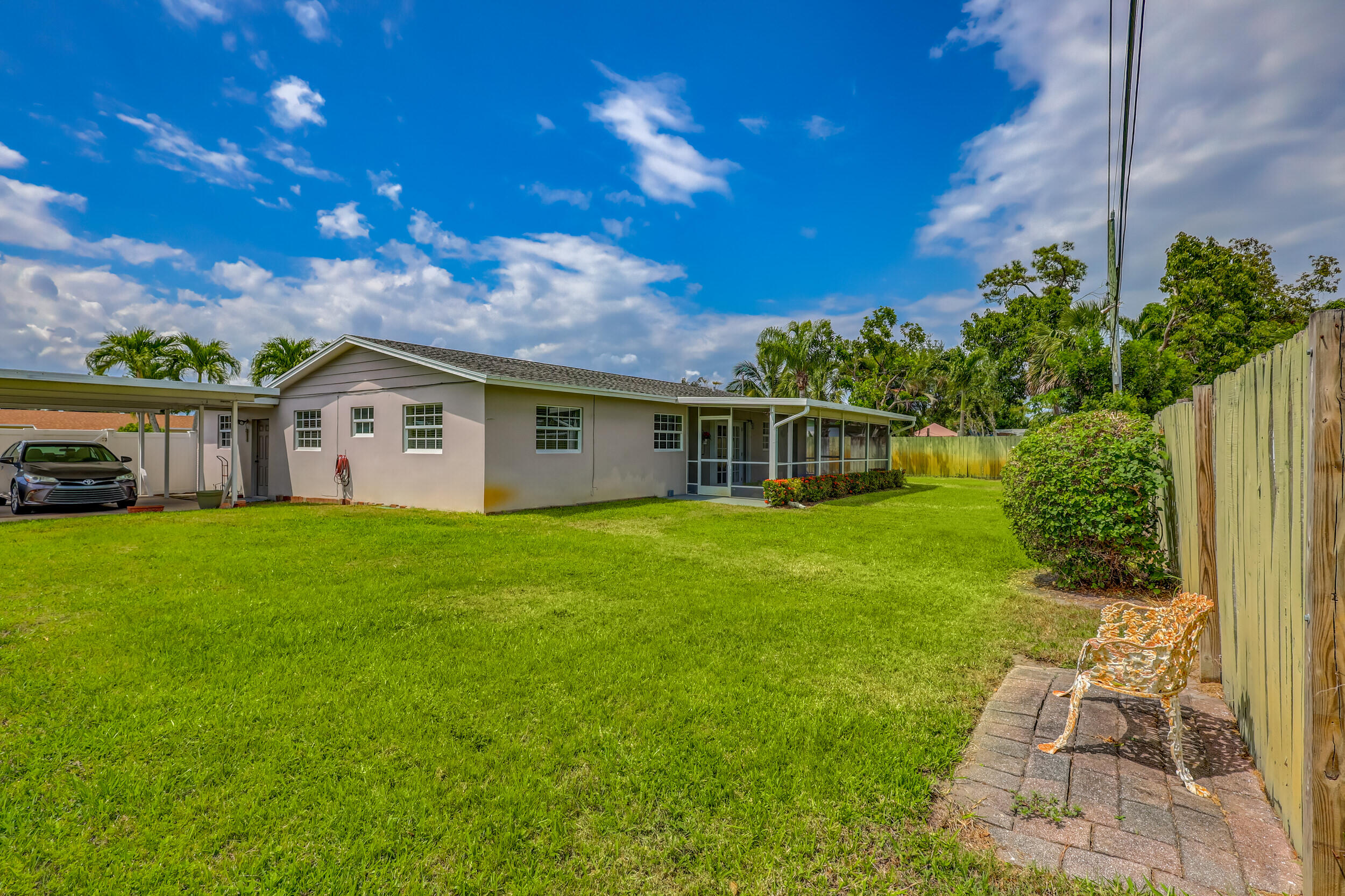 1618 Maypop Road West Palm Beach, FL 33415 - Photo 59 of 81 a view of a house with backyard and sitting area