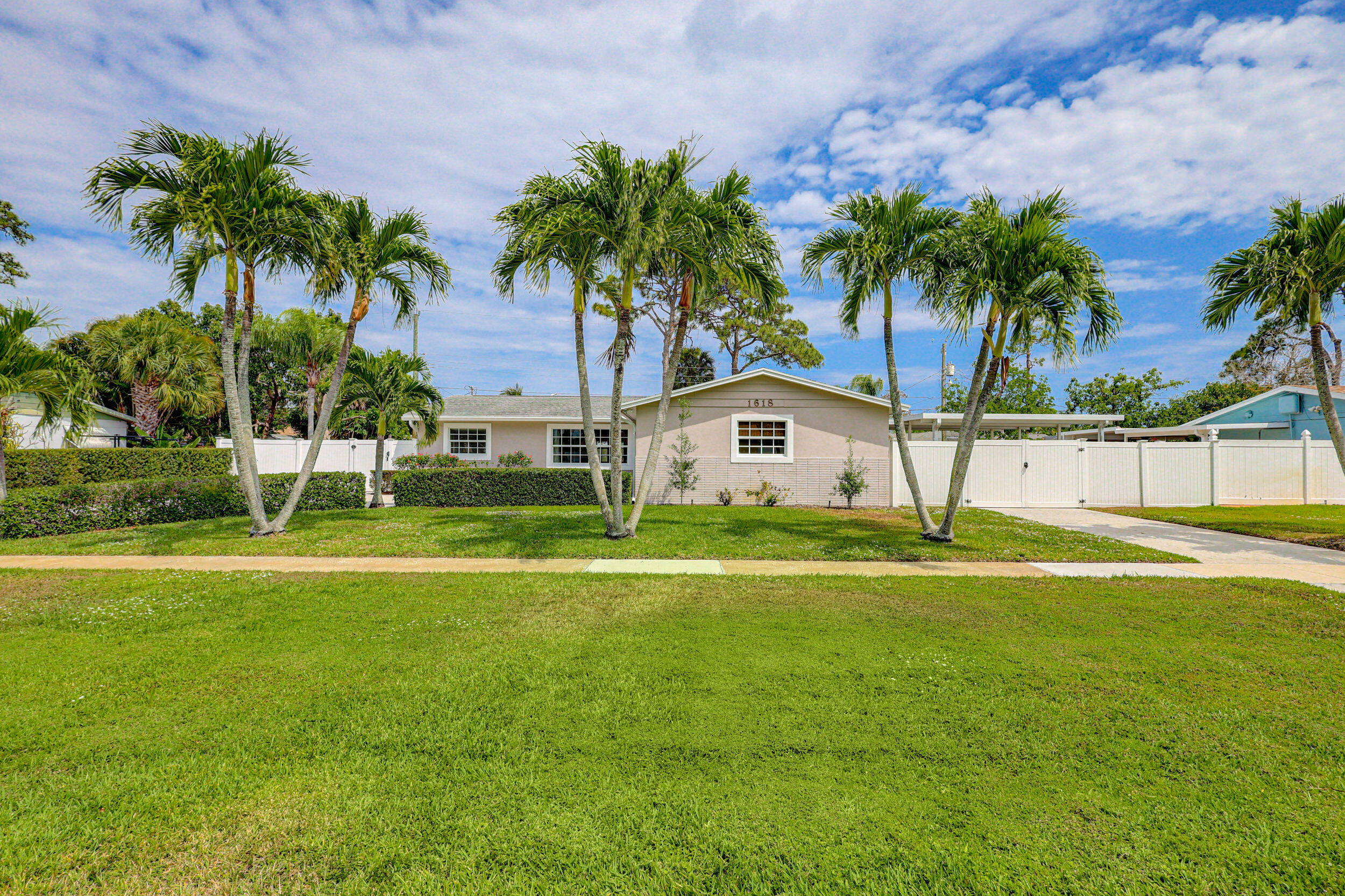 1618 Maypop Road West Palm Beach, FL 33415 - Photo 6 of 81 a front view of house with yard and palm tree
