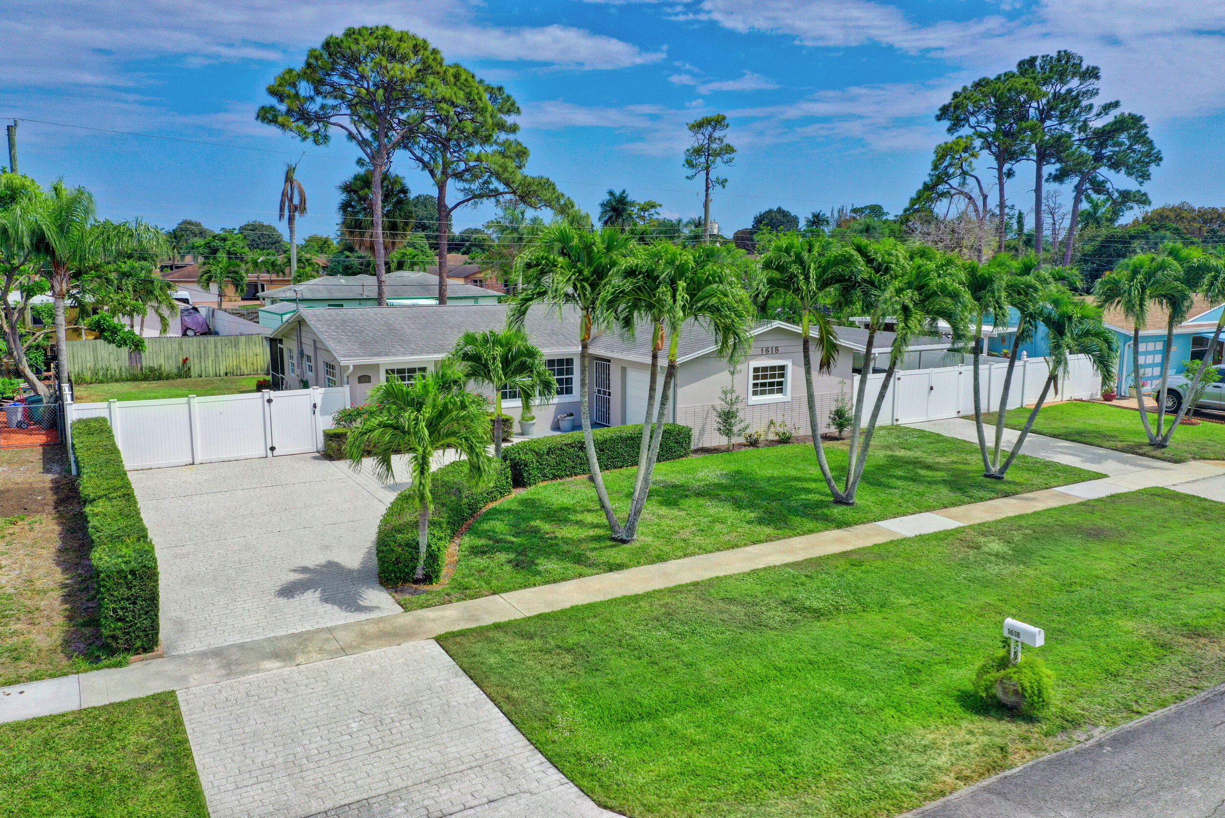1618 Maypop Road West Palm Beach, FL 33415 - Photo 67 of 81 a view of a backyard with potted plants and palm trees
