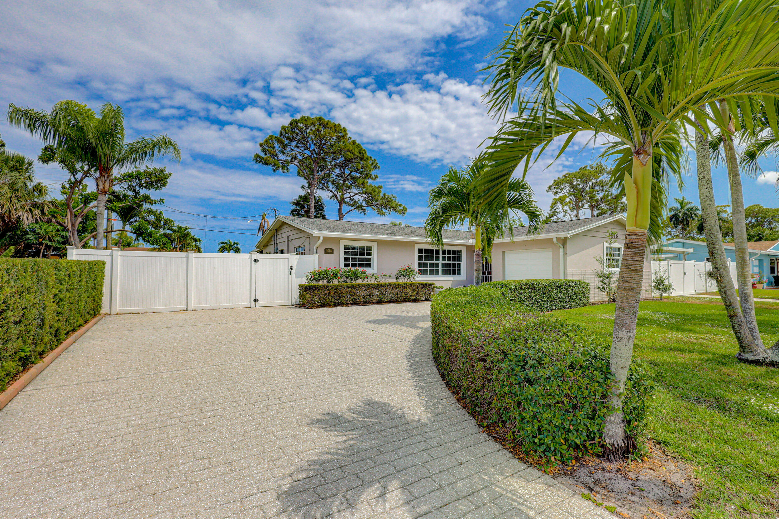 1618 Maypop Road West Palm Beach, FL 33415 - Photo 7 of 81 a front view of a house with garden