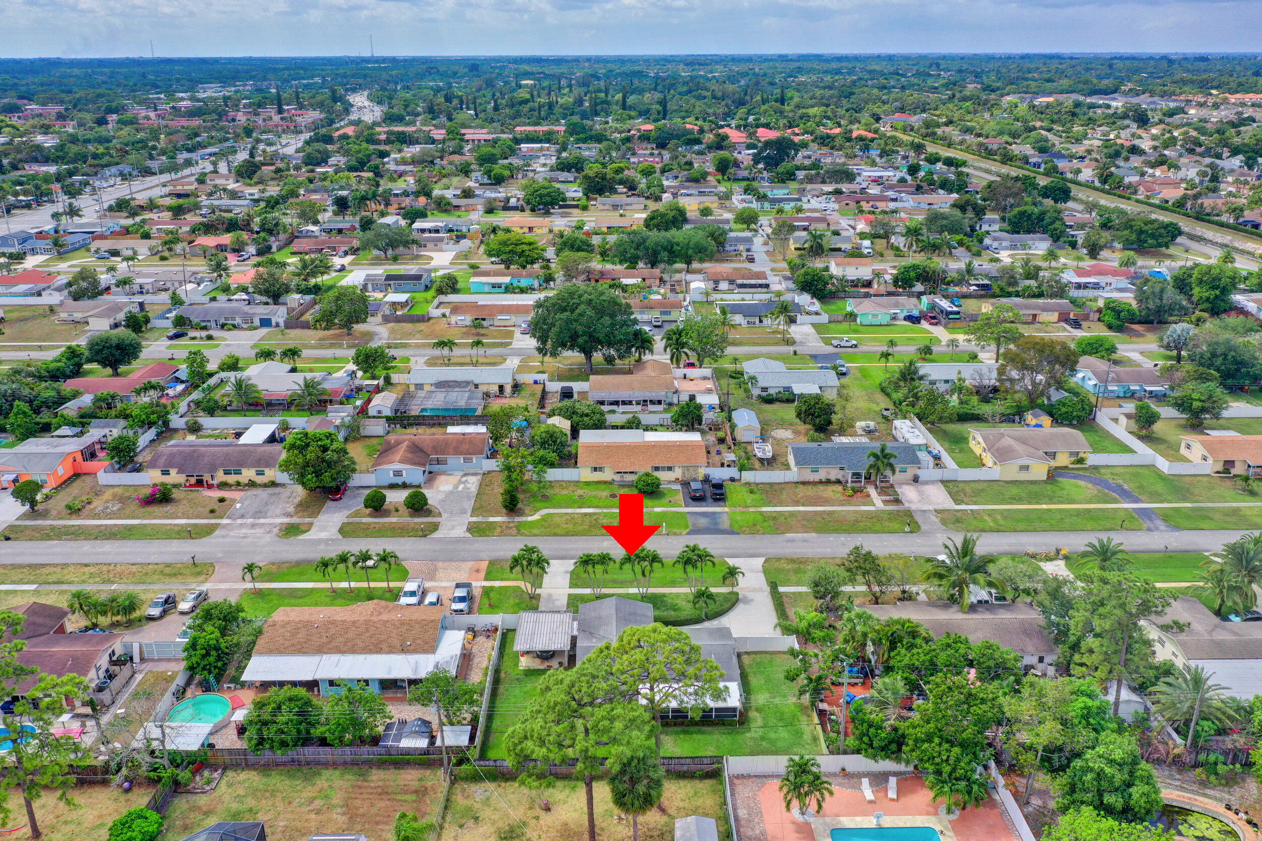 1618 Maypop Road West Palm Beach, FL 33415 - Photo 76 of 81 an aerial view of residential houses with outdoor space and trees