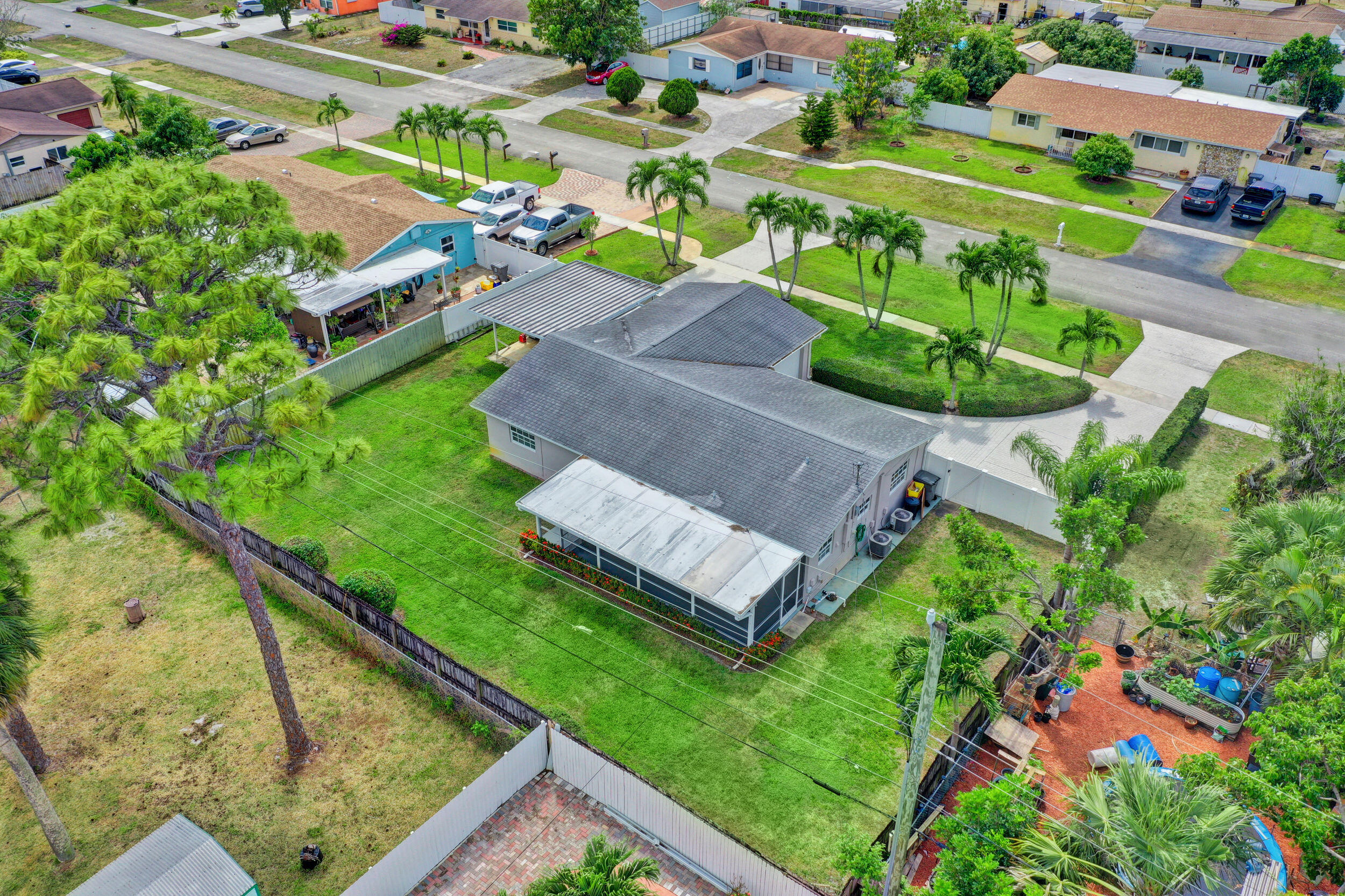 1618 Maypop Road West Palm Beach, FL 33415 - Photo 80 of 81 an aerial view of a house with a garden and swimming pool
