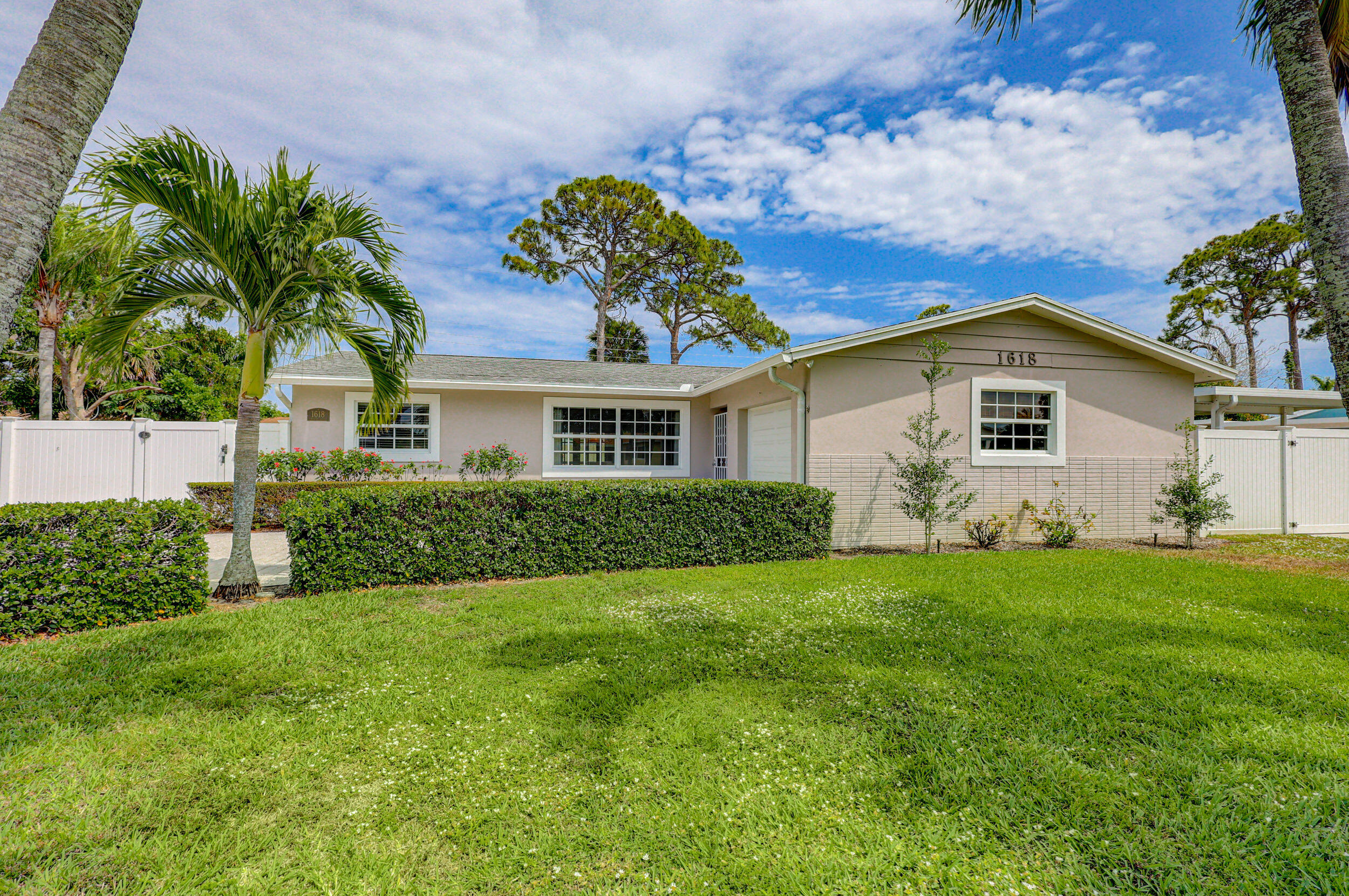 1618 Maypop Road West Palm Beach, FL 33415 - Photo 9 of 81 a front view of a house with a garden