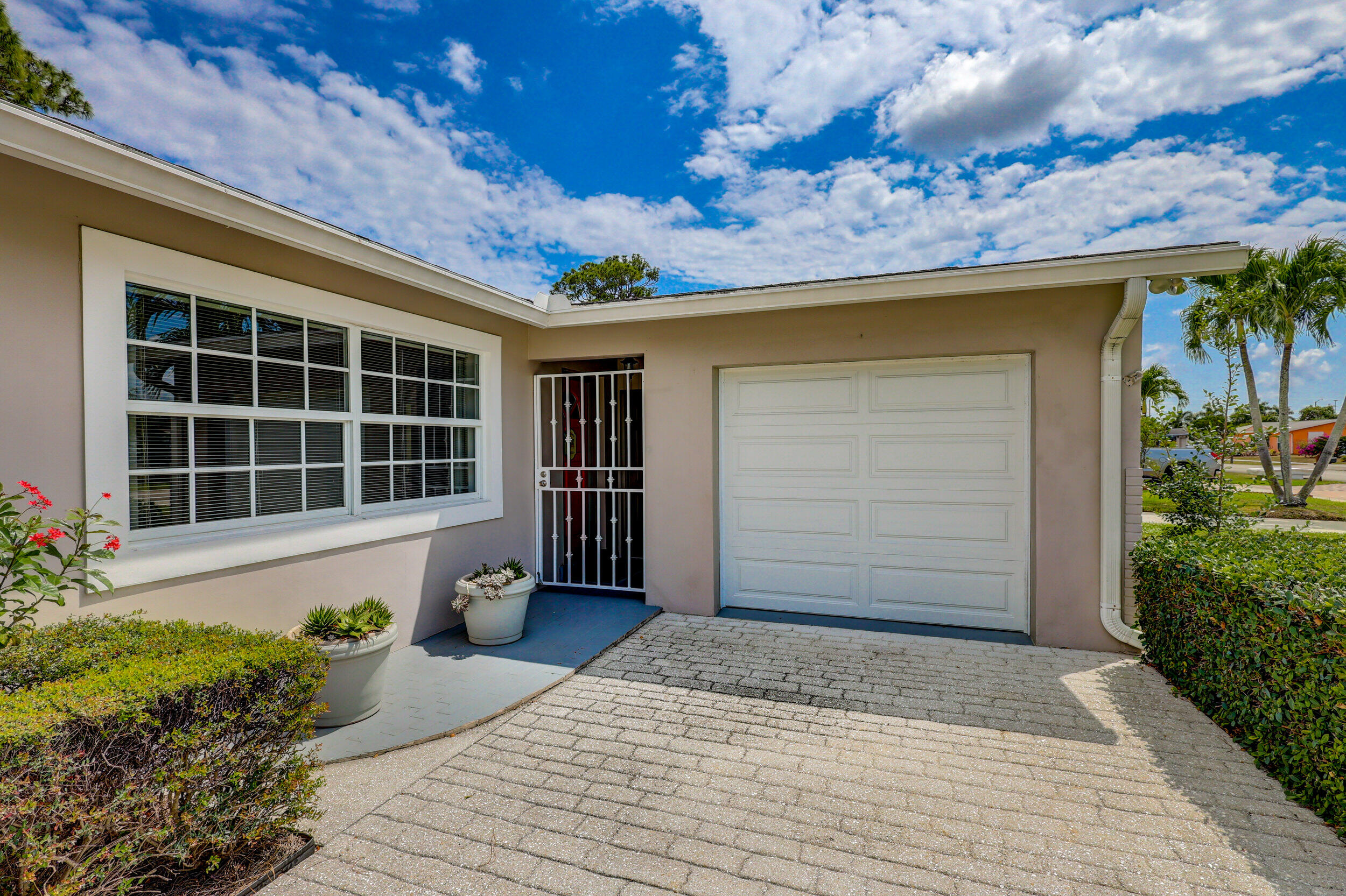 1618 Maypop Road West Palm Beach, FL 33415 - Photo 10 of 81 a front view of a house with a garden