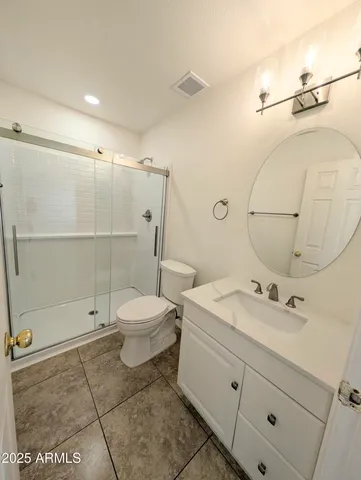 a bathroom with a sink mirror and vanity
