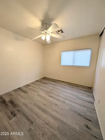 a view of a room with wooden floor