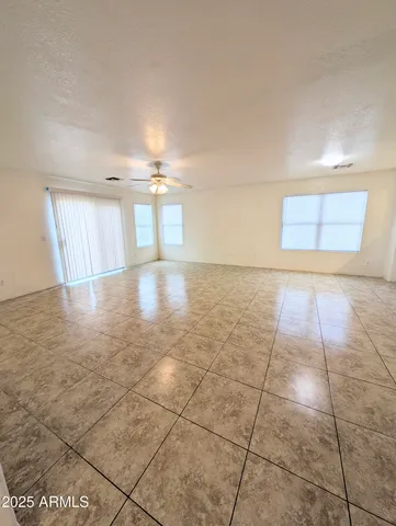 a view of a hallway to room with windows